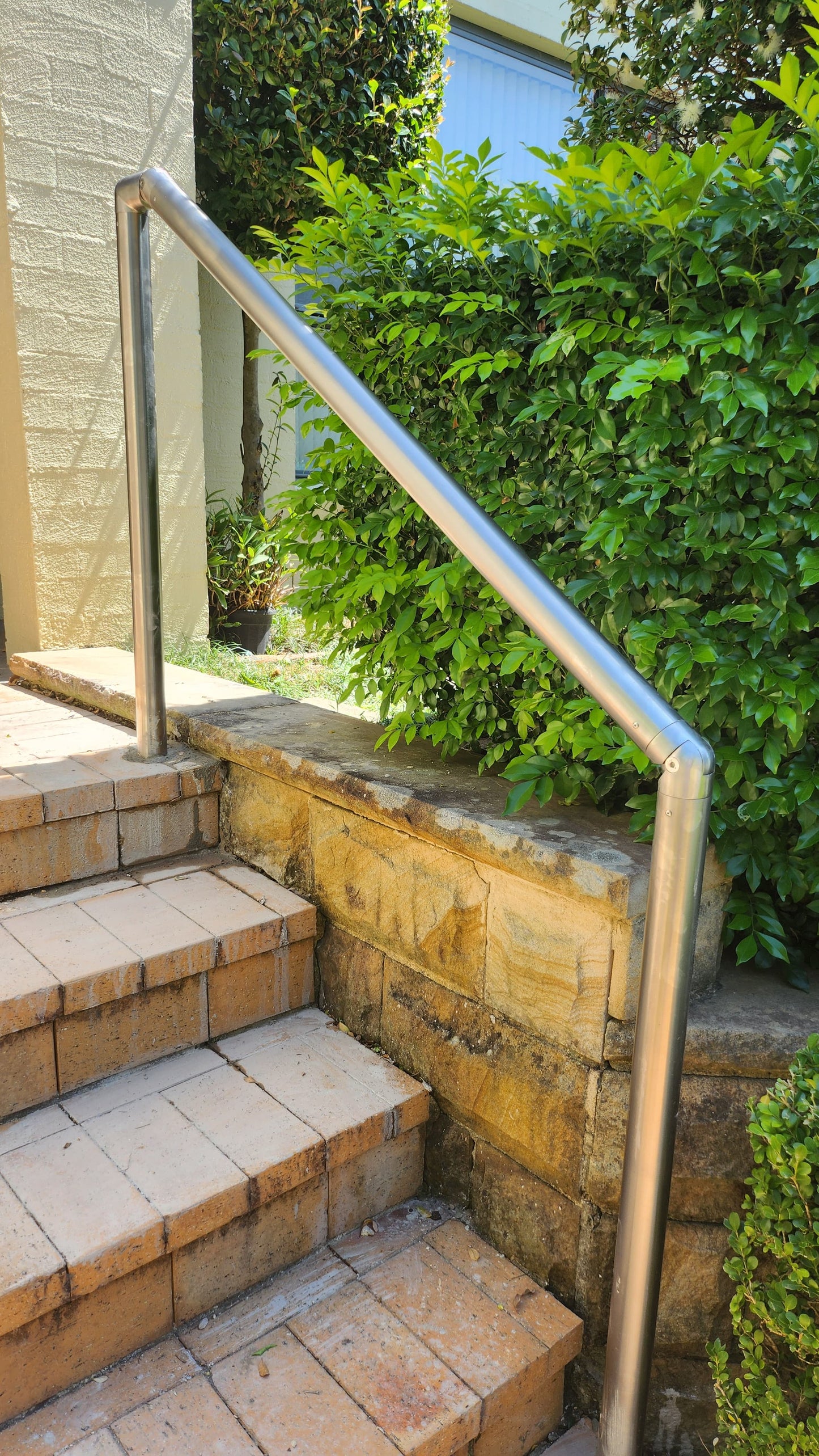 Durable stainless steel handrail providing stability for seniors on outdoor steps