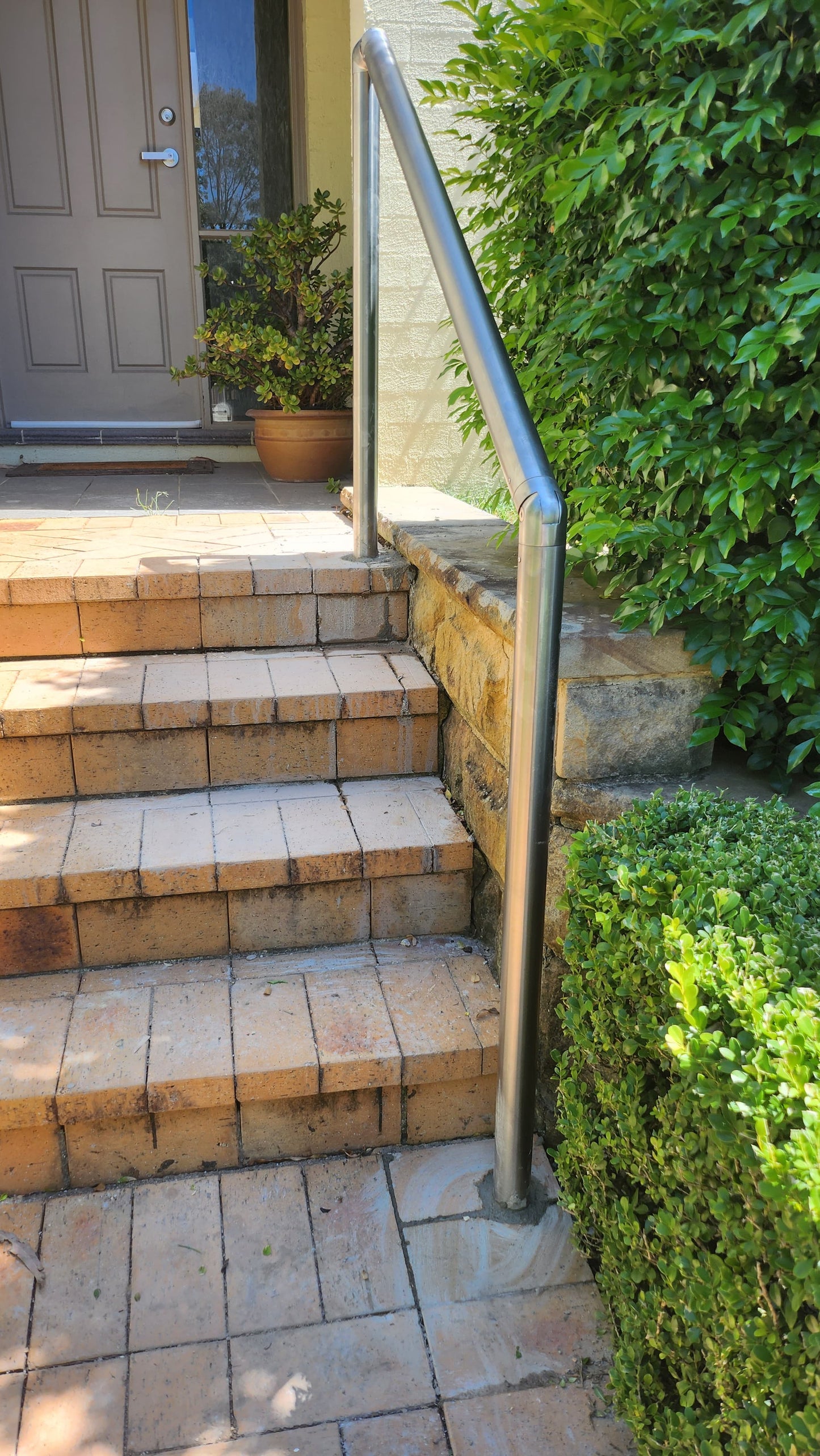 Durable stainless steel handrail providing stability for seniors on outdoor steps